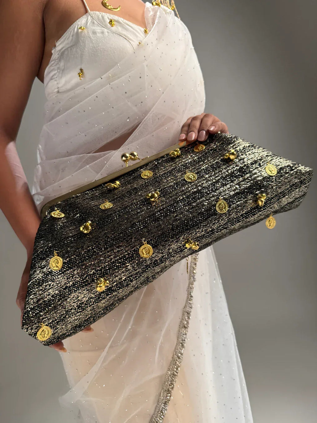 Black and gold kiss-clip oversized clutch with coin charms”

“Handcrafted black evening bag with gold detailing by Clutch It”

“Noir Royale oversized metallic clutch for weddings and events